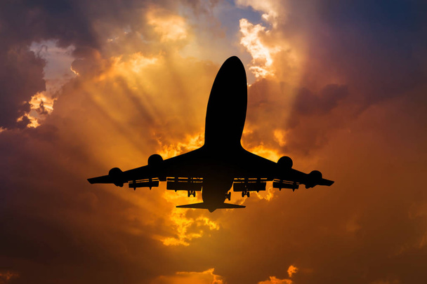   Silhouet passagier vliegtuig vliegen naar hemel op zonsondergang - Foto, afbeelding