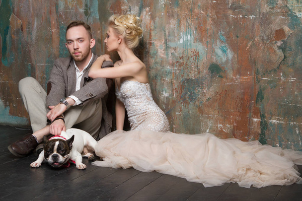 Charming happy wedding couple with cute dog - Foto, imagen