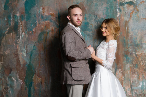 Portrait of young couple in love posing at studio dressed in cla - Foto, Imagem