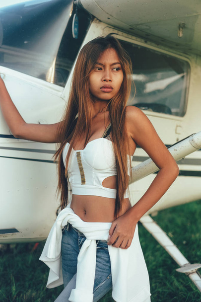 Beautiful female portrait on the airfield,late afternoon - 写真・画像