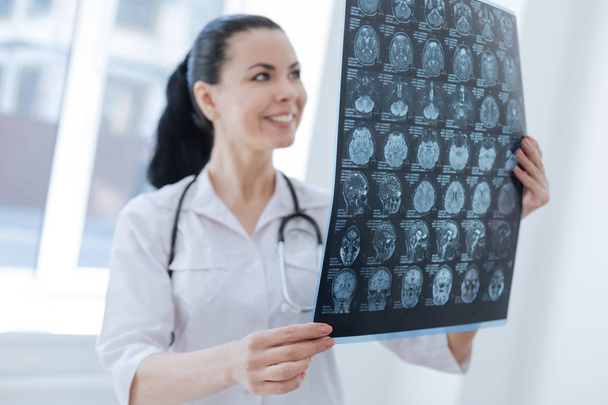 Charming radiologist monitoring brain changes at work - Foto, afbeelding