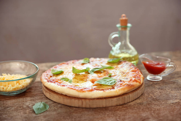 Tasty pizza on wooden table - Photo, image
