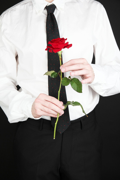 man holding rose close-up - 写真・画像