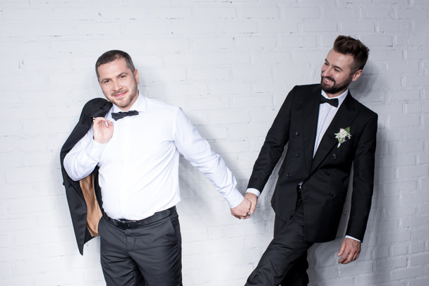 Couple of grooms holding hands - Photo, Image
