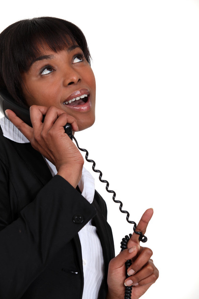 Businesswoman receiving good news over the phone - Foto, imagen