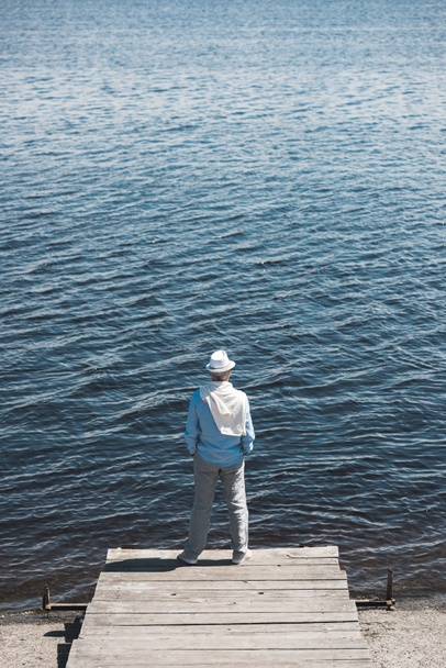 casual man standing on quay at daytime - Zdjęcie, obraz