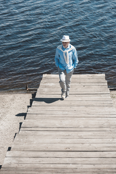 stylish senior man walking on riverside - Fotografie, Obrázek