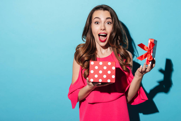 Excited cute girl in dress holding opened present box - Foto, immagini