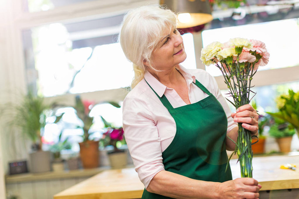 Woman working in florist shop - Photo, Image