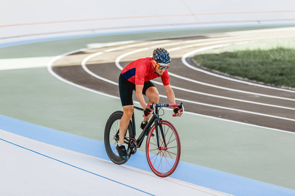 Racing cyclist on velodrome outdoor - Foto, Bild