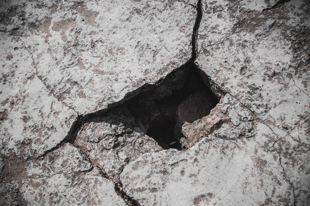 A photo of hole in the crack cement concrete wall surface texture, the conceptual background, closeup - Zdjęcie, obraz