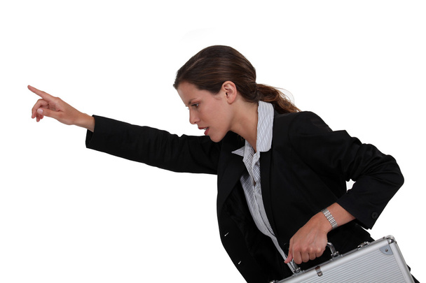 Businesswoman holding metal briefcase and pointing - Φωτογραφία, εικόνα