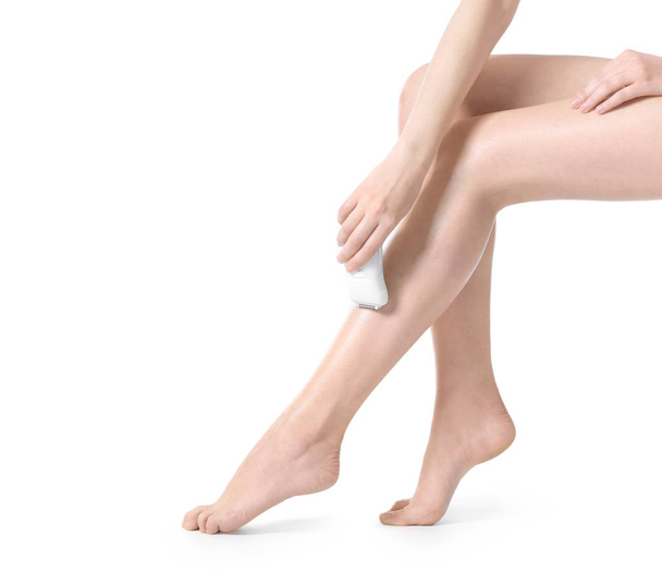 Beautiful young woman epilating legs - Фото, зображення
