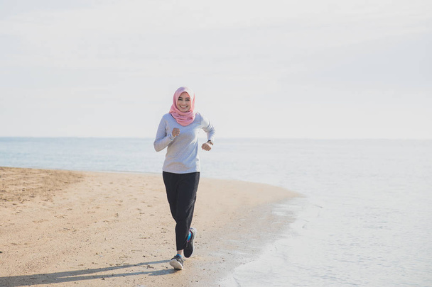 happy sporty woman wearing hijab  - Photo, Image