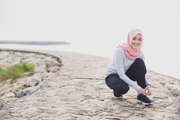 beautiful sporty woman wearing hijab  - Fotó, kép