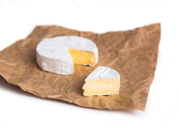 Fresh slice Camembert cheese natural, on Kraft paper - Fotoğraf, Görsel