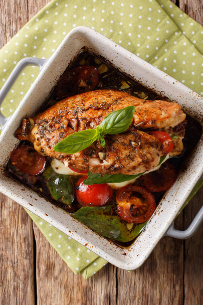 Delicious chicken fillet baked with caprese close-up in a baking - Photo, Image