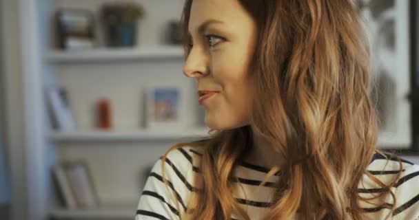 Portrait of attractive young woman looking at the camera and smiling. Close up. Slow motion. Soft light - Footage, Video