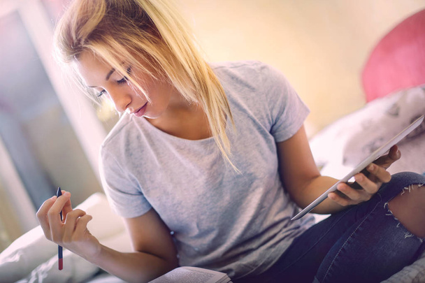 Young blond woman studying - 写真・画像