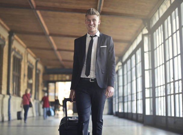 Young businessman with suitcase - Foto, Imagen