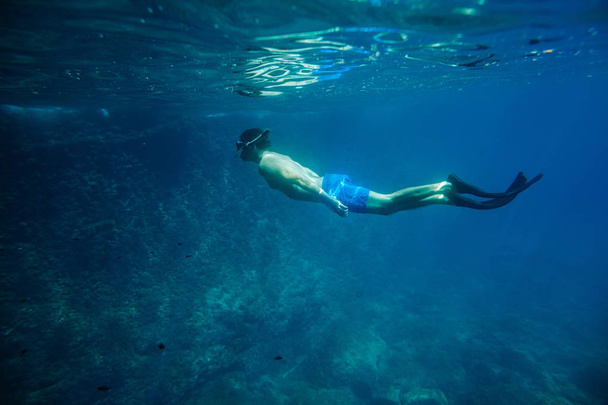 man swim underwater in snorkel - 写真・画像