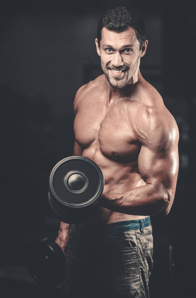 Handsome power athletic man on diet training pumping up muscles - Φωτογραφία, εικόνα