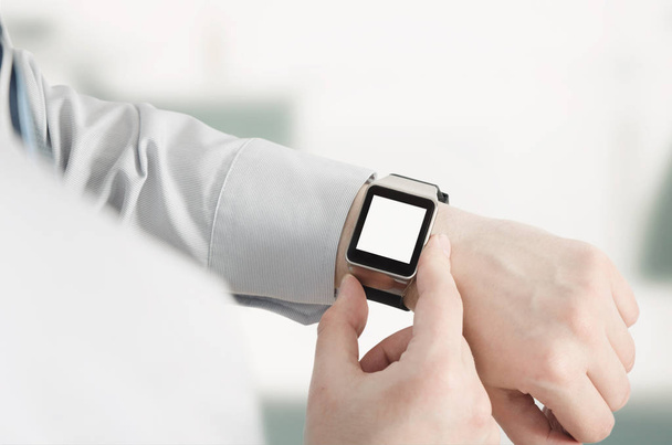 Man using smartwatch with e-mail notifier - Fotó, kép