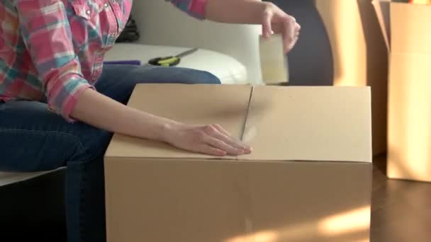 Woman quickly packing box. - Footage, Video
