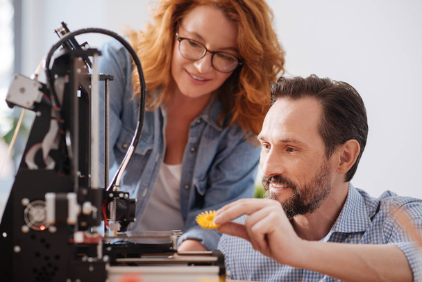 Delighted positive man holding a 3d printer detail - Photo, Image