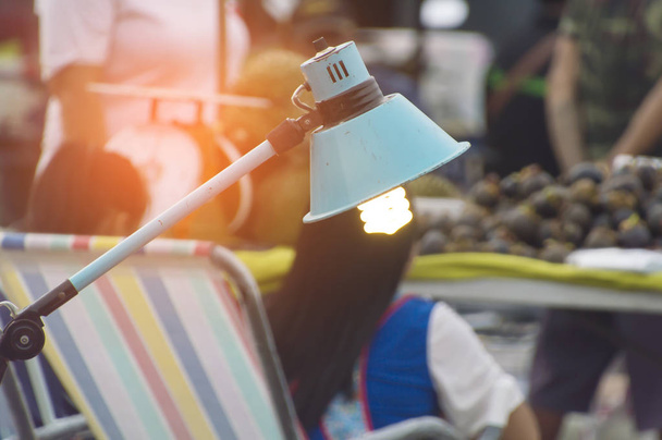Energy saving light bulb blured market background. - Photo, Image