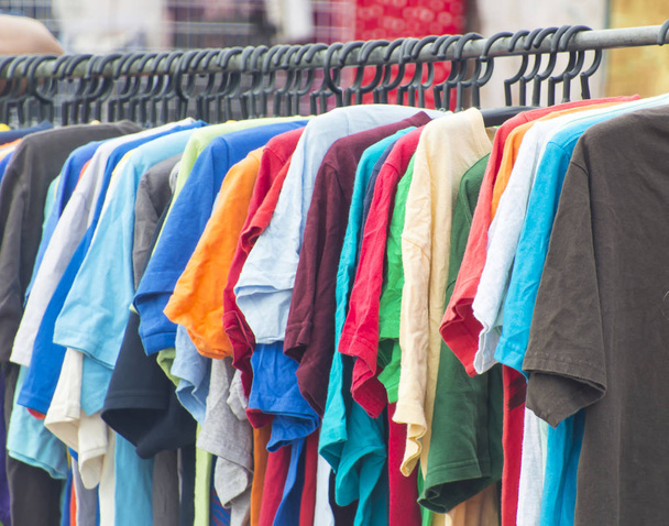 Row of hanged colorful T-shirt. - Photo, Image
