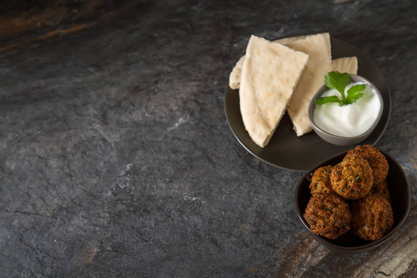 Middle Eastern traditional dishes. Falafel with sour cream. Vege - Photo, image