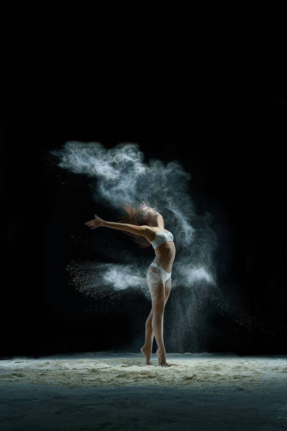 Girl in a cloud of white dust studio portrait - 写真・画像
