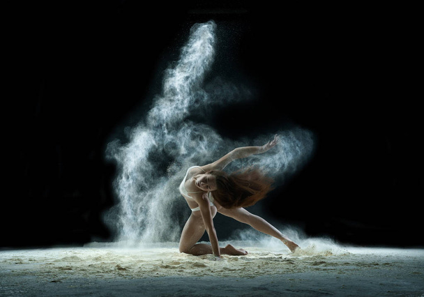 Girl in a cloud of white dust studio portrait - Fotoğraf, Görsel