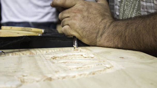 Hombre tallando madera
 - Foto, imagen