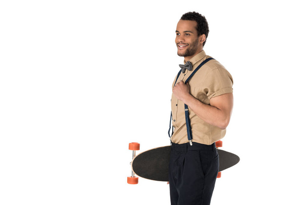Stylish young man with skateboard  - Фото, изображение