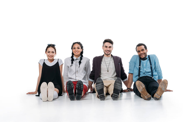 smiling multiethnic friends sitting on floor - Foto, Imagen