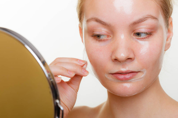 Woman removing facial peel off mask. - Photo, Image