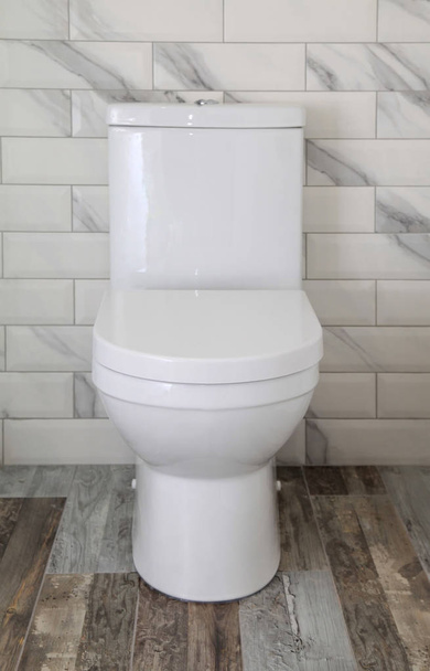White toilet bowl in a bathroom - Fotoğraf, Görsel