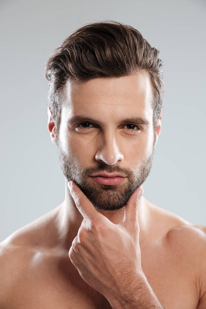 Portrait of a young sexy naked man touching his chin - Fotoğraf, Görsel