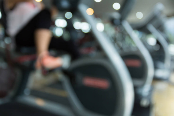 blurred woman cycling burn fat on bicycle cardio machine - Photo, Image