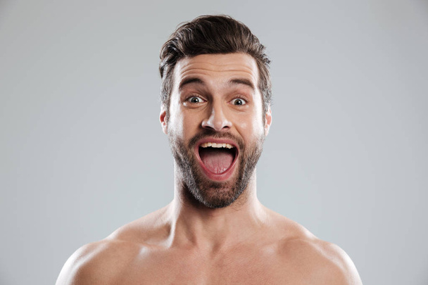 Excited bearded man with naked shoulders and open mouth - Fotoğraf, Görsel
