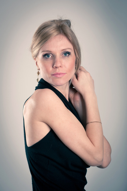 Beautiful blonde caucasian woman with elegant black dress - Foto, Imagen