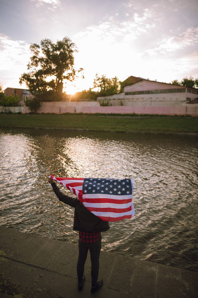 Inspired US patriot holds national flag outdoor - Photo, Image