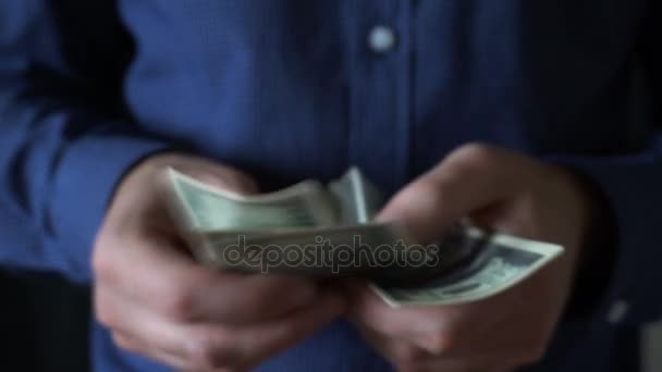 reaches out,asks for money,give a hundred dollar bill,paid by the job - Materiał filmowy, wideo
