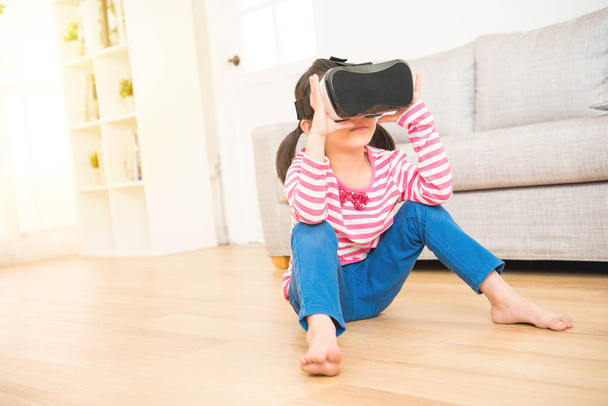 girl looking in a VR goggles device - 写真・画像