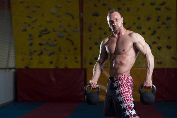 Muscular Man Exercising With Kettle-bell - Photo, image