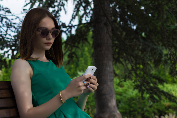 Young pretty girl, smartphone, outdoor - Φωτογραφία, εικόνα