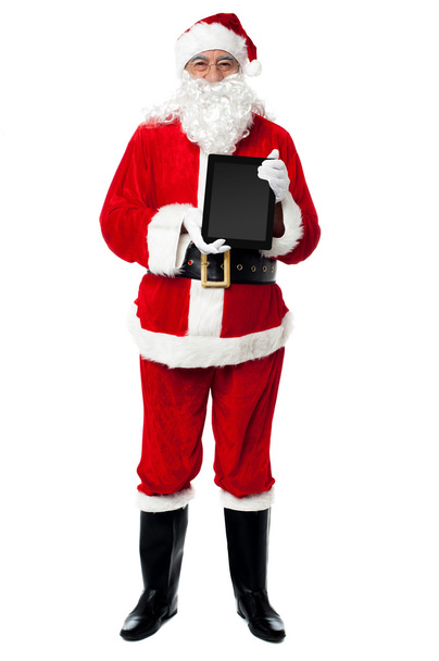 Saint Nicholas displaying a brand new tablet device - Photo, Image