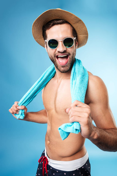 Image of happy man holding towel on shoulders - Foto, immagini